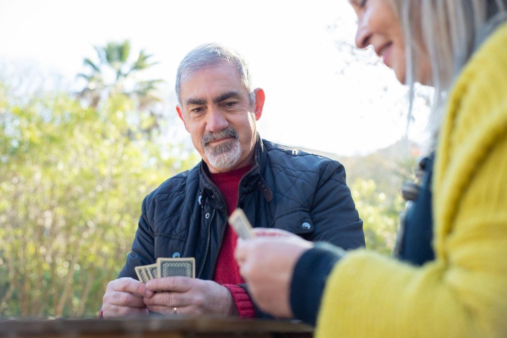 Residents playing cards outdoors at a Whitby retirement residences community.